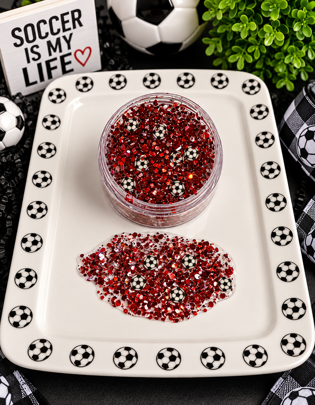 Red chunky glitter with tiny soccer ball confetti in a jar on a soccer-themed tray