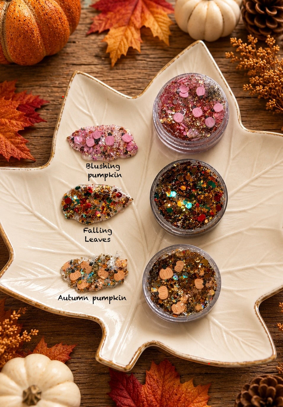 Three jars of fall-themed chunky glitter — Blushing Pumpkin, Falling Leaves, and Autumn Pumpkin — with pumpkin confetti on a leaf-shaped dish