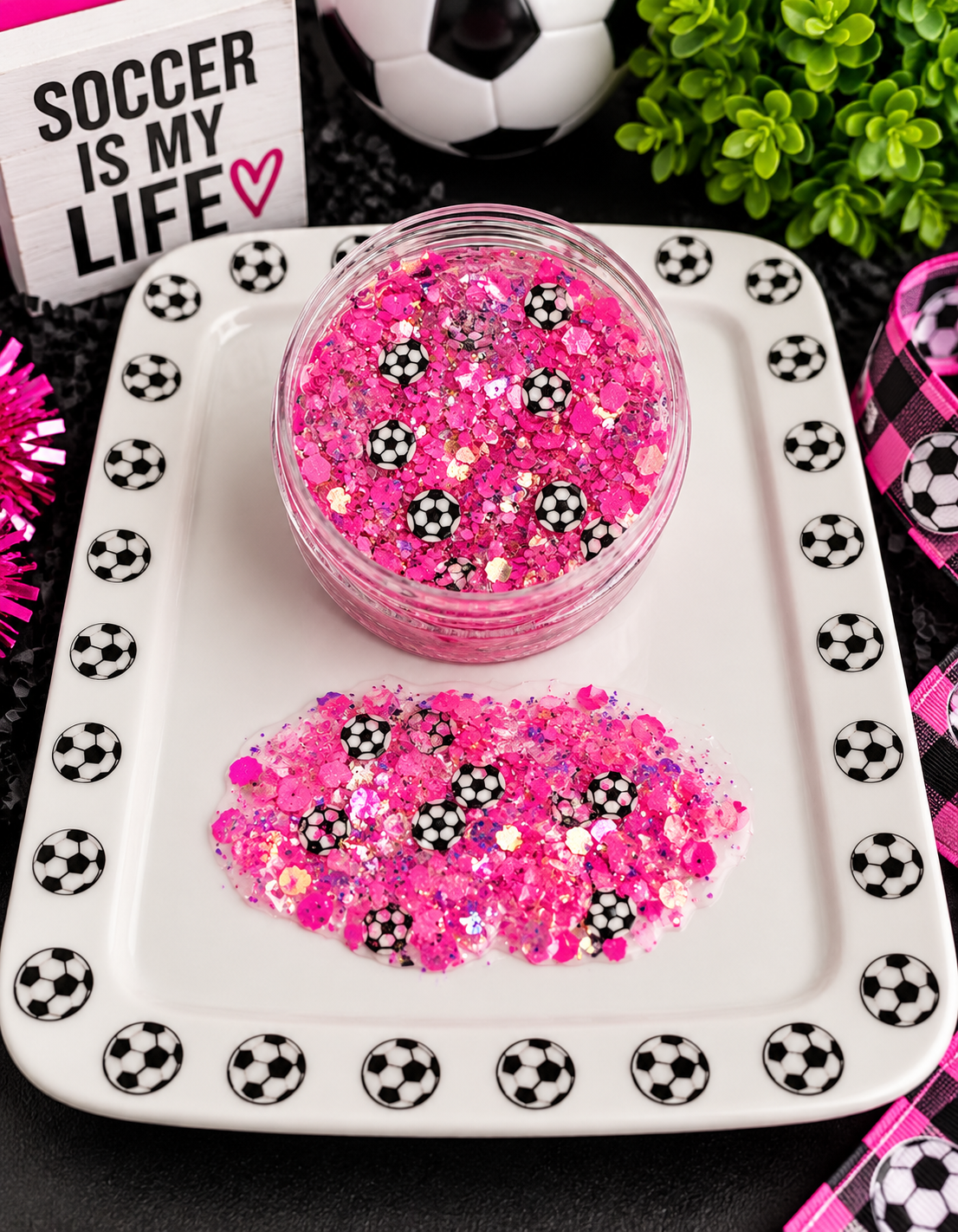 Pink chunky glitter with tiny soccer ball confetti in a jar on a soccer-themed tray