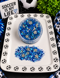 Blue chunky glitter with tiny soccer ball confetti in a jar on a soccer-themed tray